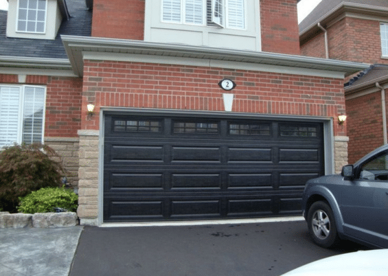 black garage door on a red brick house