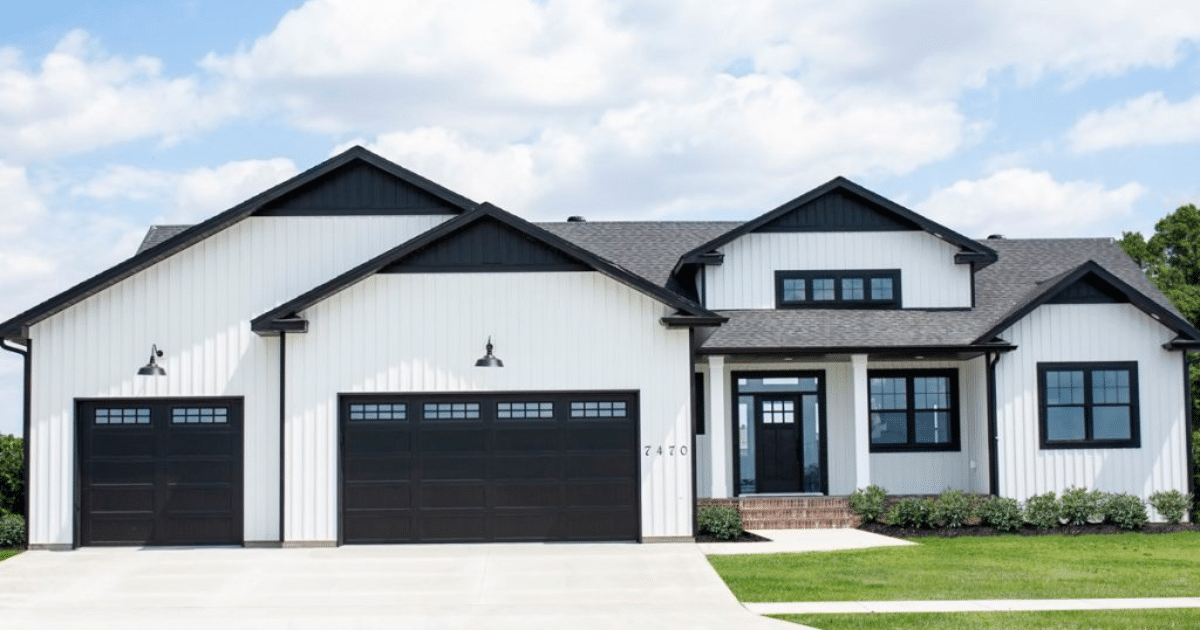 white house with black garage doors